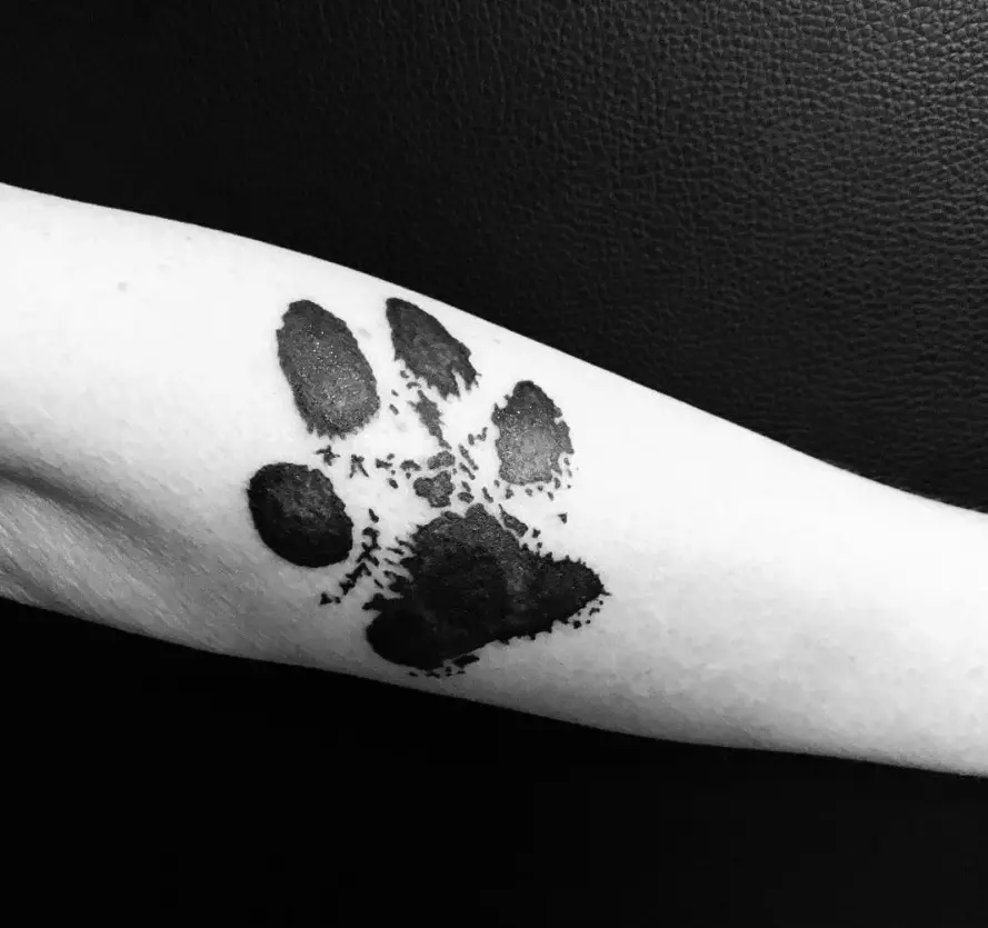 paw print tattoo on the wrist