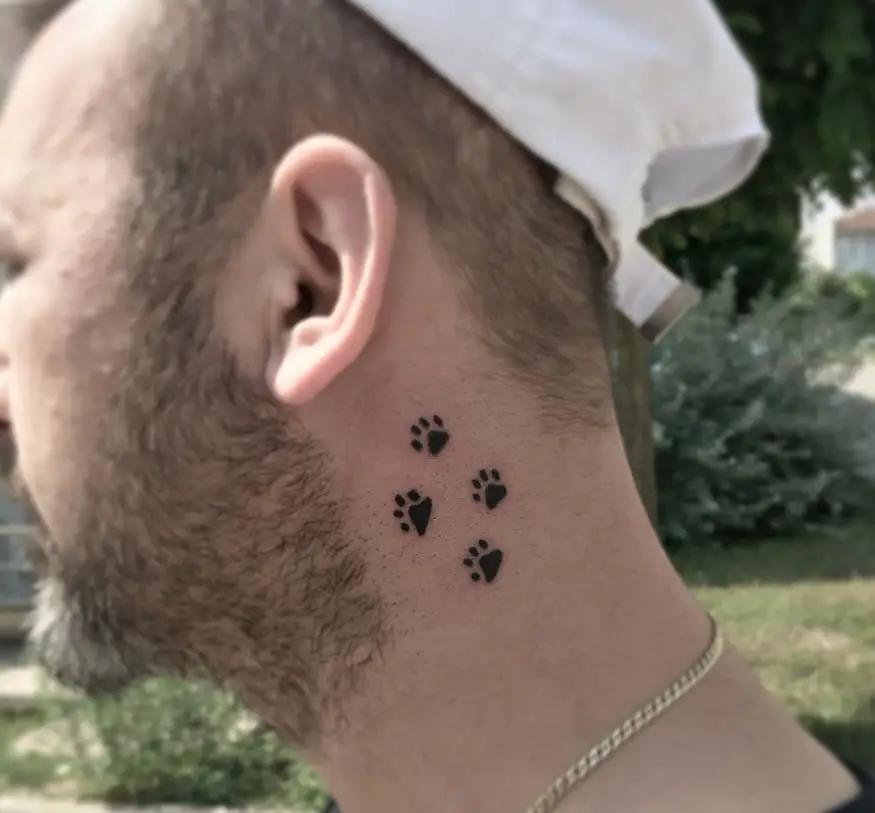 four small print tattoos on the neck of a man