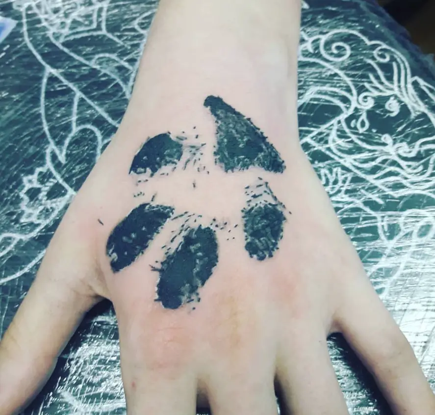 paw print tattoo on the hands