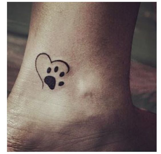 heart outline with a paw print tattoo on the ankle