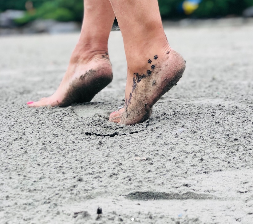 paw print tattoo on the feet