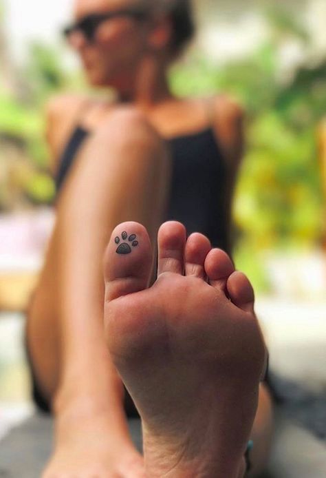 a paw print on the toes of a woman