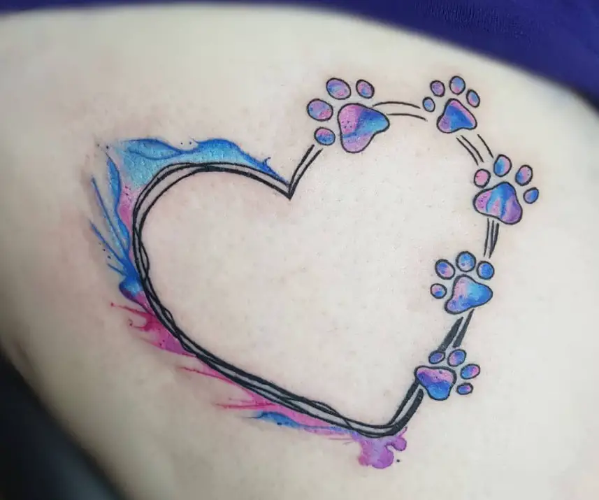 heart outline with paw prints in purple, blue, and pink colors tattoo on the thigh