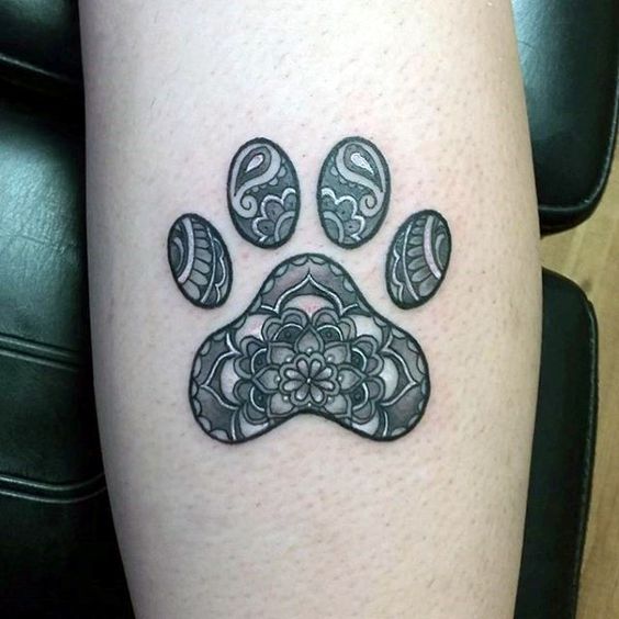 paw print with mandala design tattoo on the leg