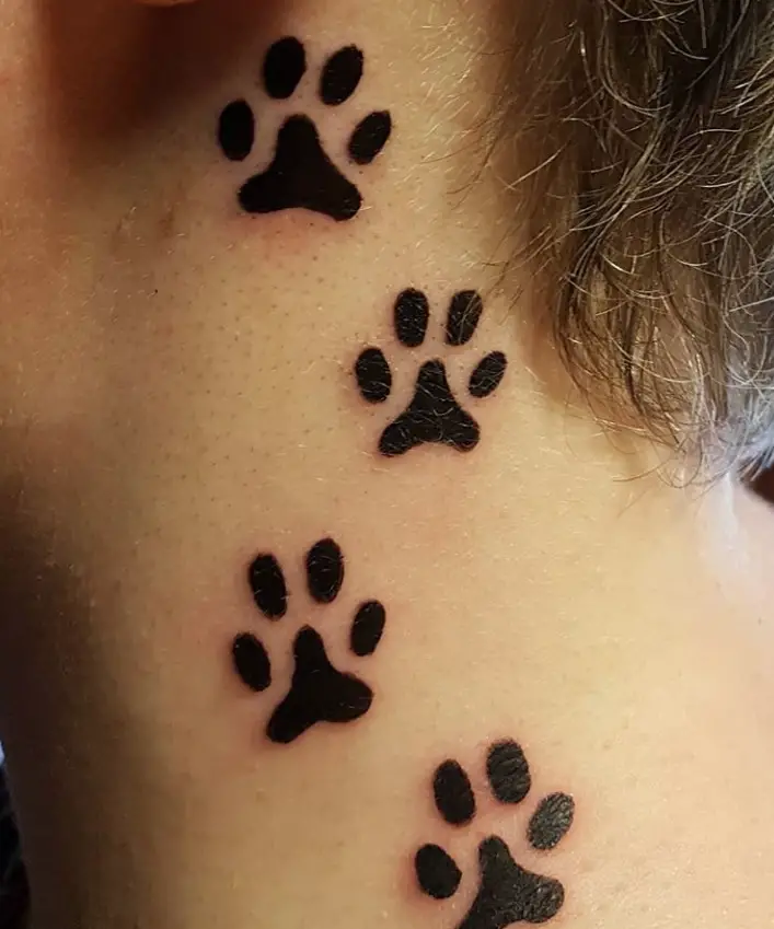 two paw print tattoo on the back of the ears of the woman