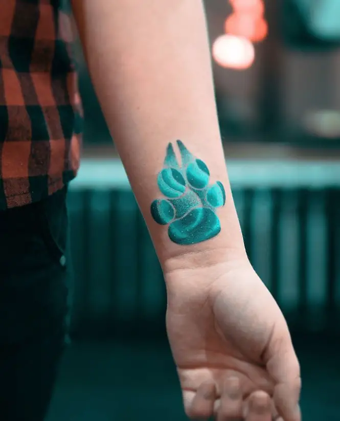 blue Paw Print tattoo on the wrist