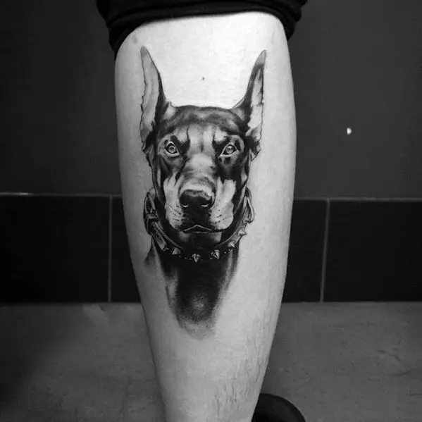 black and gray furious face of Doberman tattoo on the leg