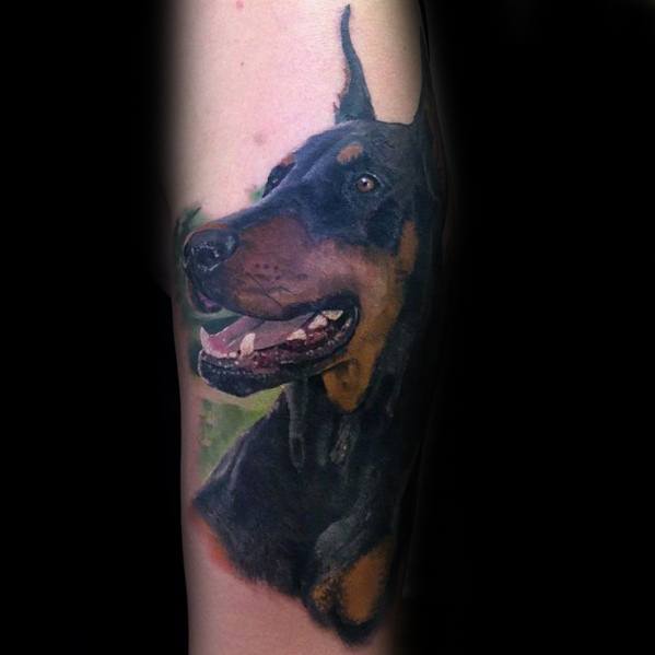 sideview face of a Doberman tattoo on the leg