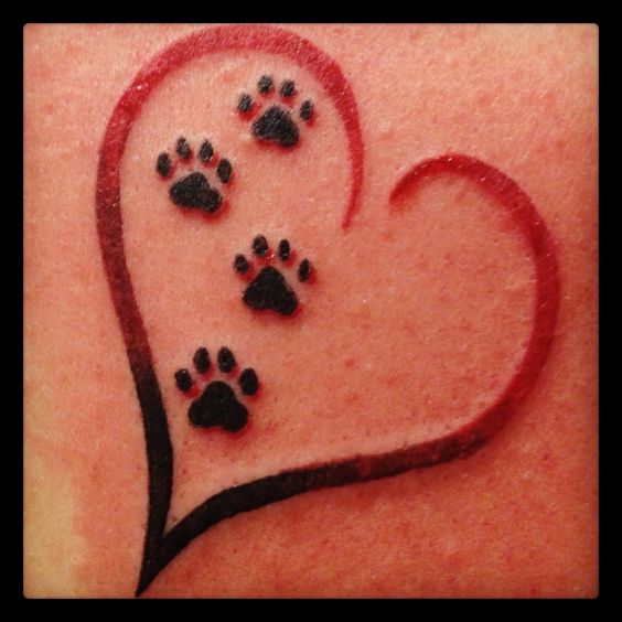 four paws in a red heart tattoo