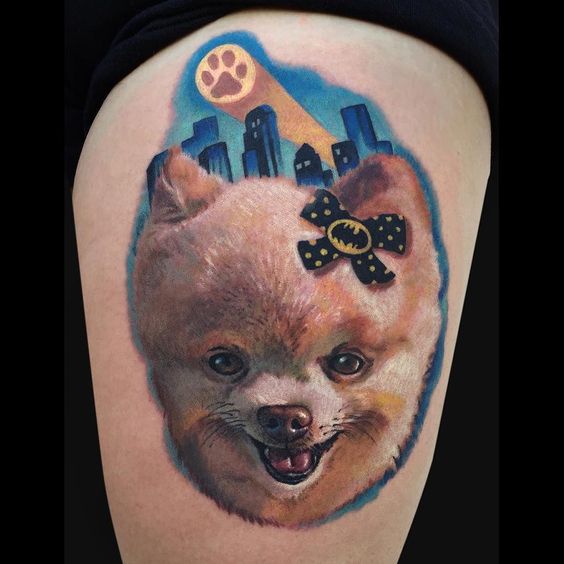 realistic smiling face of a Pomeranian with a blue sky and buildings background tattoo