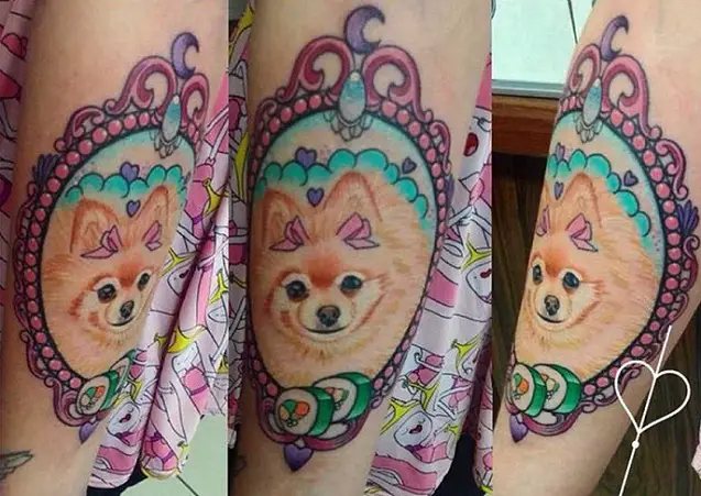 cute face of a red Pomeranian Tattoo in a pink vintage frame tattoo