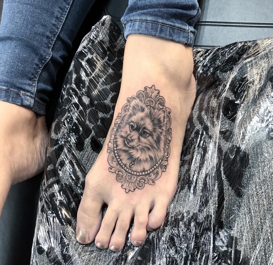 Pomeranian Dog in a vintage frame tattoo on the feet