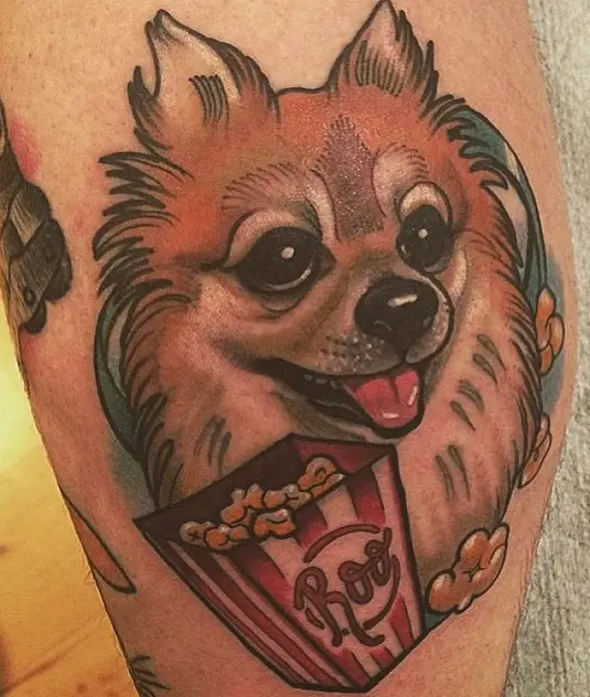 animated smiling red Pomeranian with popcorn tattoo on the leg