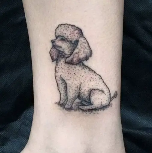 A sitting poodle tattoo on the leg