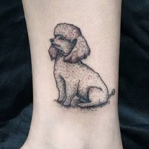 A sitting poodle tattoo on the leg