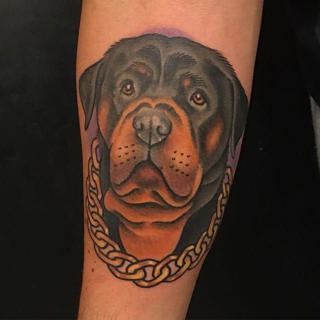 sad face of Rottweiler Tattoo on the forearm