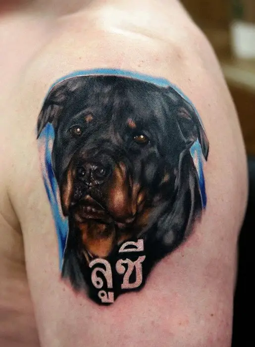 sad face of Rottweiler Tattoo on the shoulder