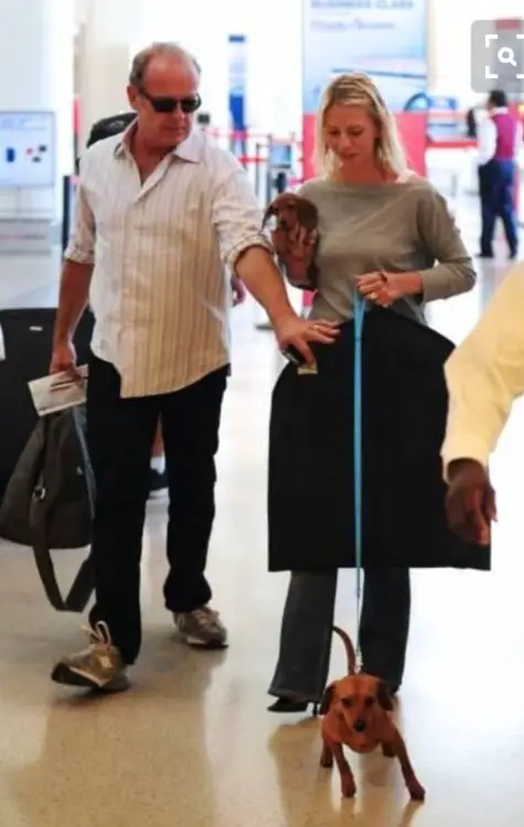 Kelsey Grammer walking inside the mall with her Dachshund