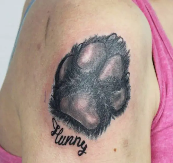 3D paw print with name tattoo on shoulder