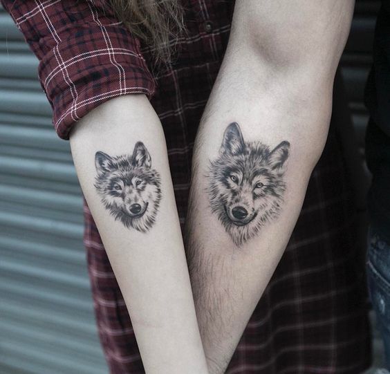 face of a Husky tattoo on the couple's arms