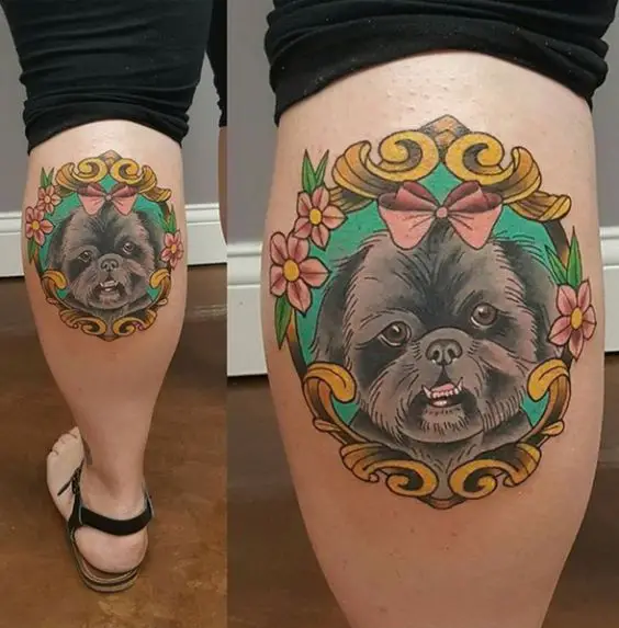 face of Shih Tzu Tattoo inside a flowery and golden frame tattoo on the leg