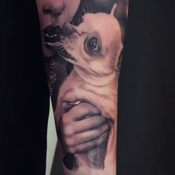girl kissing a Chihuahua tattoo