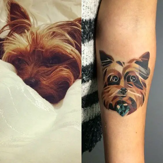 artistic face of a brown yorkie tattoo on the forearm