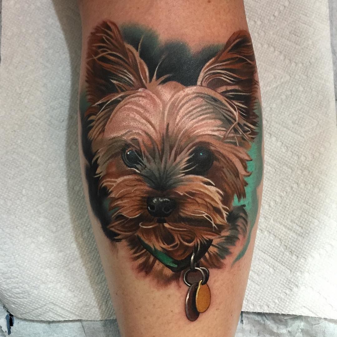 realistic Yorkie with green shadow tattoo on the leg