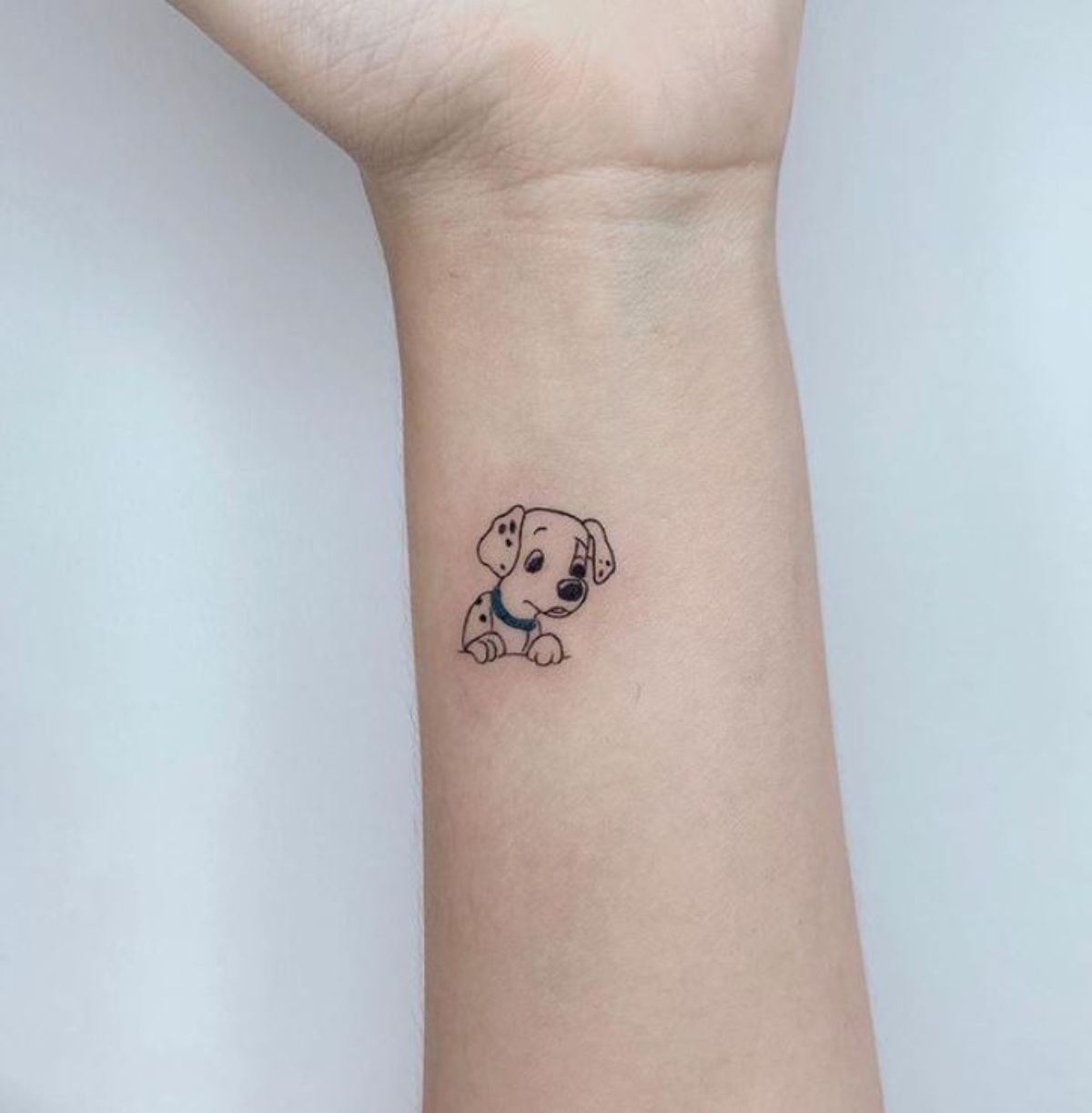 dalmatian puppy cartoon character tattoo on the wrist