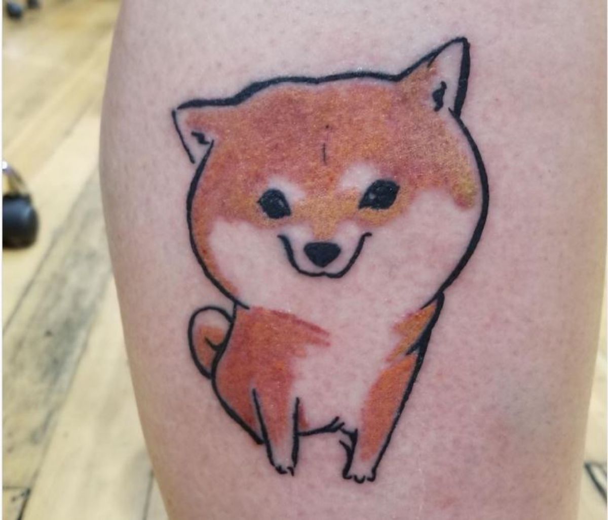 cute smiling Shiba Inu tattoo on the leg