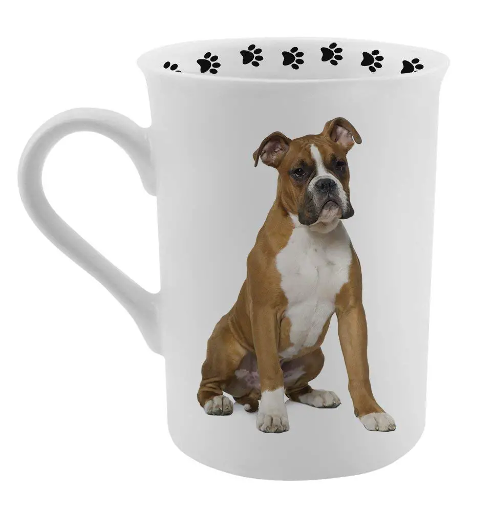 A white mug printed with a sitting boxer dog and with paw prints
