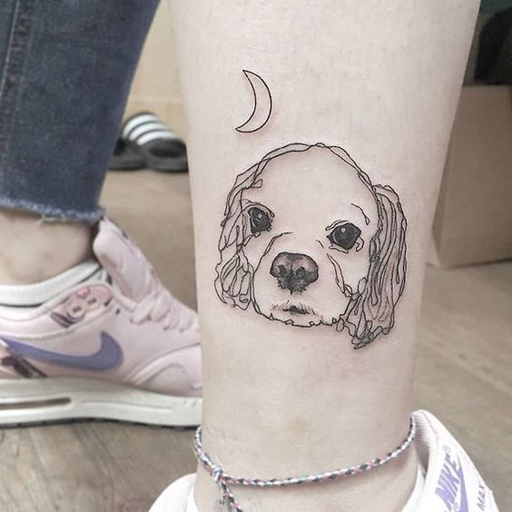 face of Cocker Spaniel puppy with crescent moon Tattoo on the ankle