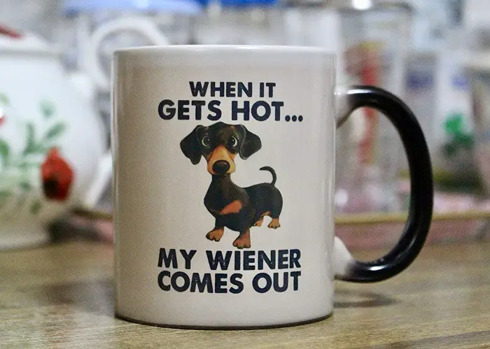 A Heat Sensitive and color changing mug printed with dachshund and - When it gets hot... my weiner comes out