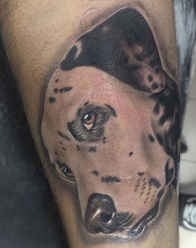 sideview face of Dalmatian tattoo on the leg