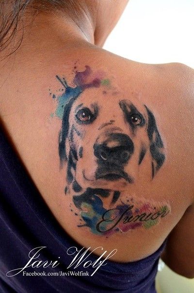 face of Dalmatian with purple, blue and green watercolor design on its side tattoo on shoulder back