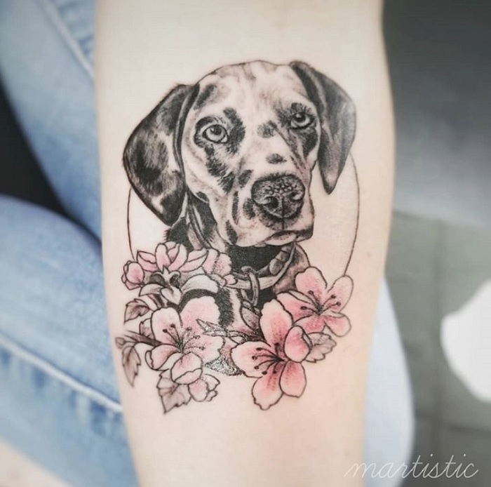 Dalmatian with pink flowers tattoo on forearm