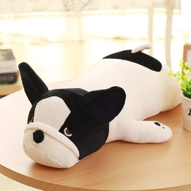 A French Bulldog plush lying on top of the table