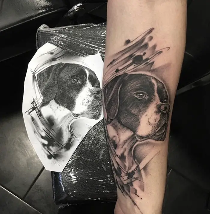 black and gray looking sideways German Shorthaired Pointer dog tattoo on the forearm