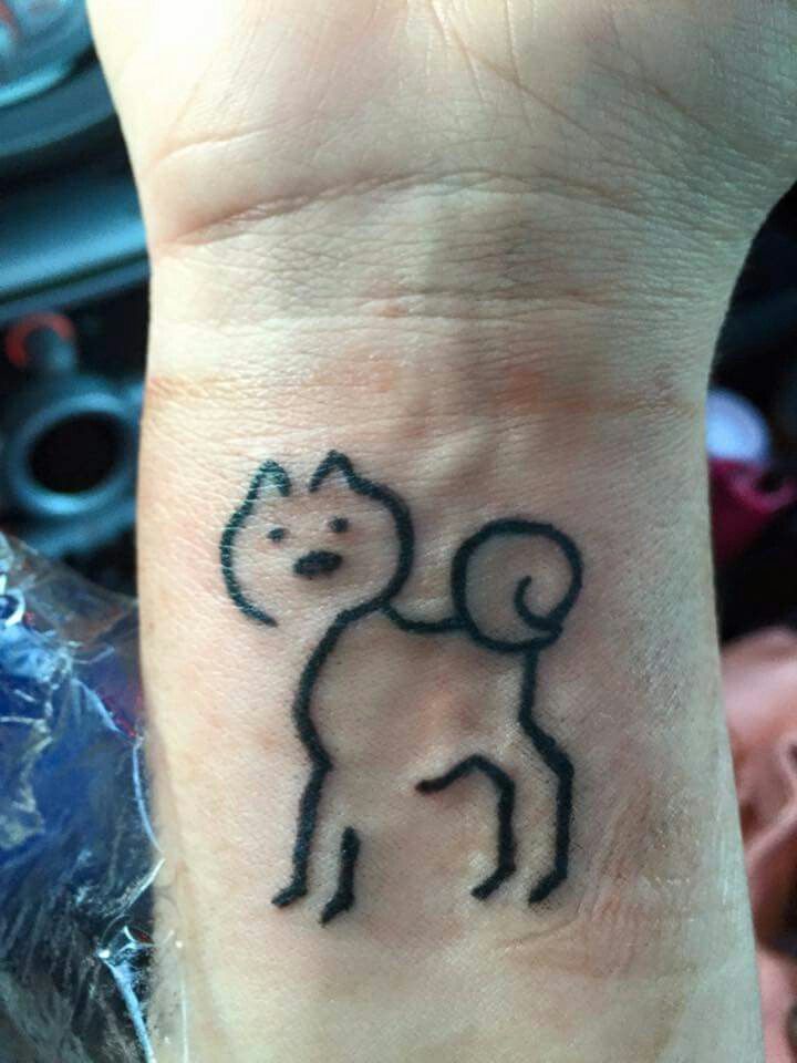 outline of Shiba Inu dog tattoo on the wrist