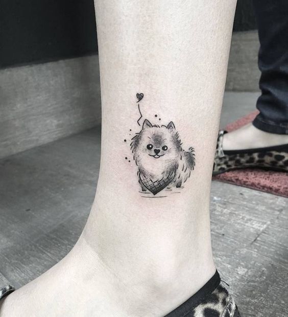 small dog with heart tattoo on the ankle