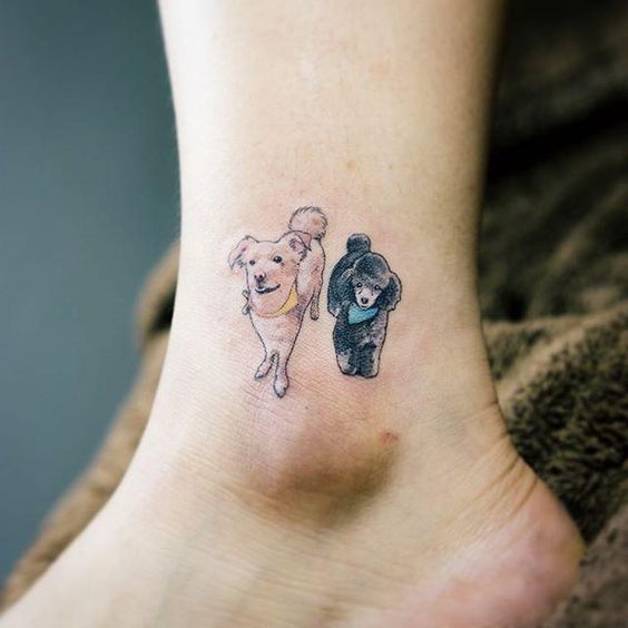 two small dogs tattoo on the ankle