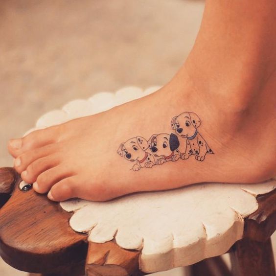 three dalmatation puppies tattoo on the feet