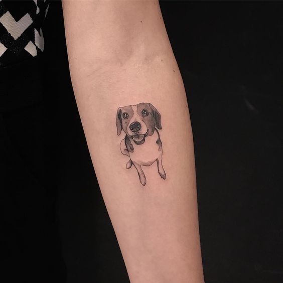 small dog tattoo on the forearm