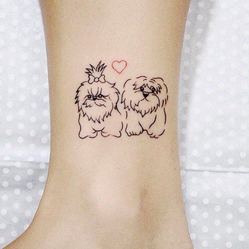 outline of shihtzu dogs with red heart in between tattoo on the ankle