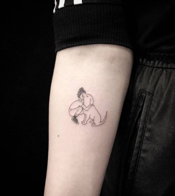 girl hugging a dog tattoo on the forearm