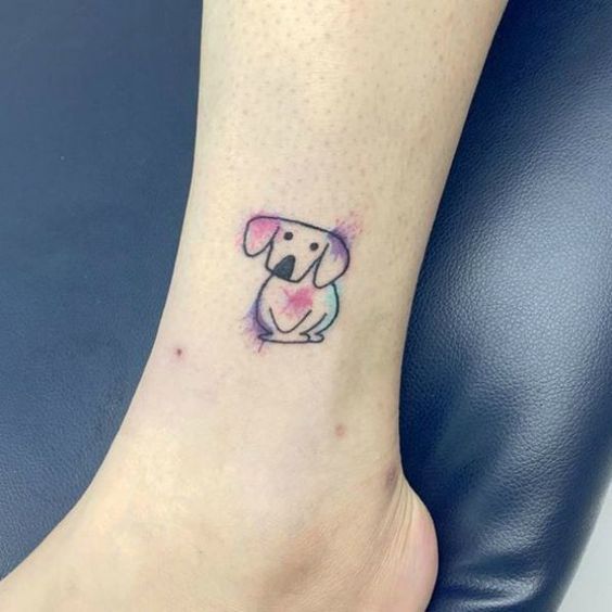 outline of sitting dog with watercolor tattoo on the ankle