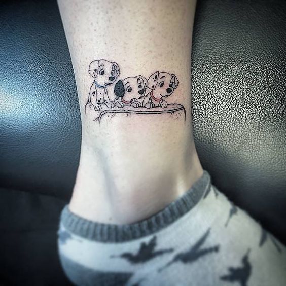 three dalmatian dog character tattoo on the ankle