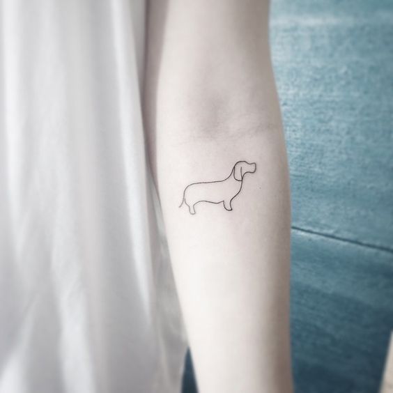 outline of dachshund tattoo on forearm