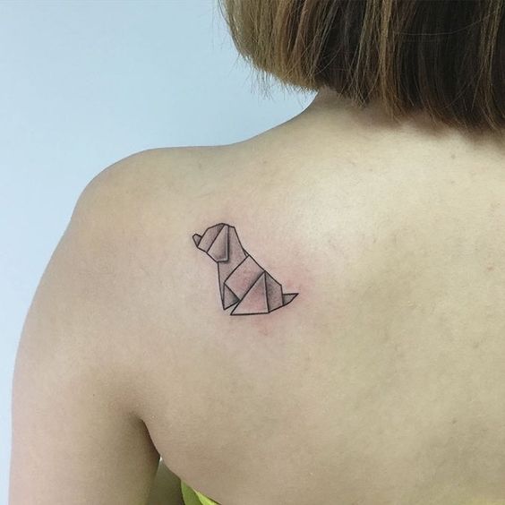 small origami dog tattoo on the back