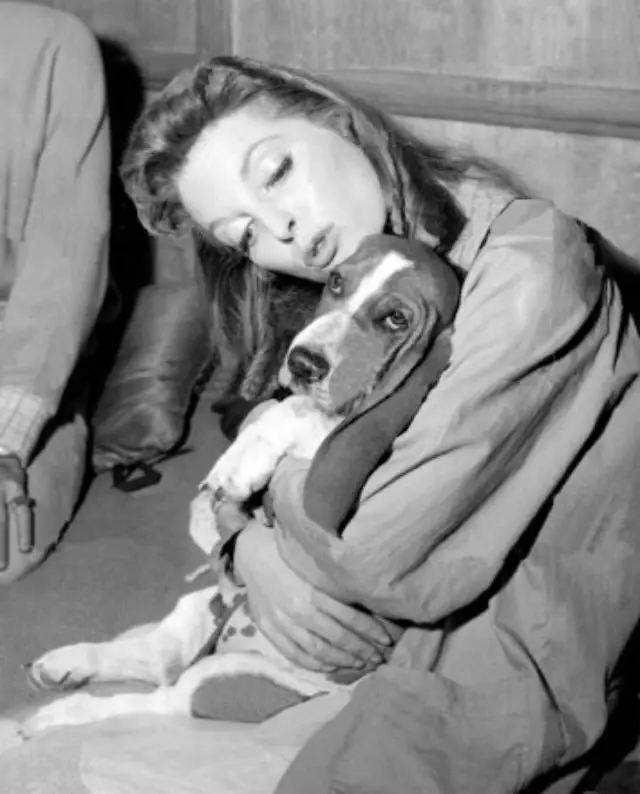 black and white photo of Julie London hugging its Basset Hound dog